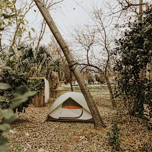 The campsite is tucked by the fence next to the farmhouse. There's enough space for one large tent or two small tents.
