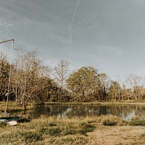 The swimming hole, complete with a jumping deck and rope swing, picnic table, and kayak.