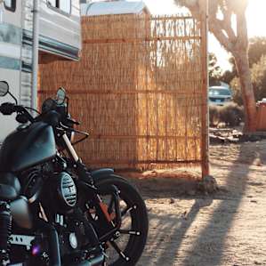 Porta-potty and privacy screen, adjacent to the camper.