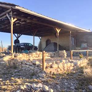 Here you can see part of the fire ring, the carport structure, and my friend cooking on nice outdoor dinette set.