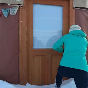 Entrance to yurt, covered in snow.