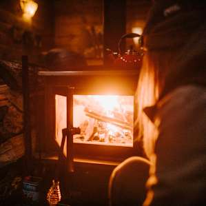 Stoking the wood burning fireplace.