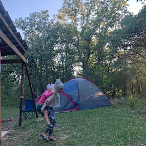 Nice open campsite surrounded by trees.