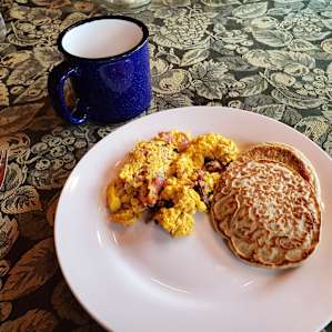 Homemade gluten free pancakes with farm fresh eggs and bacon
