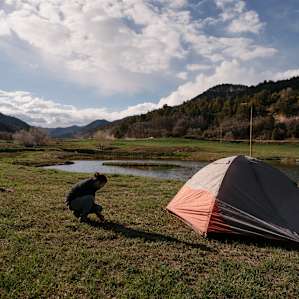 Setting up my tent near the water. Super soft and flat ground.