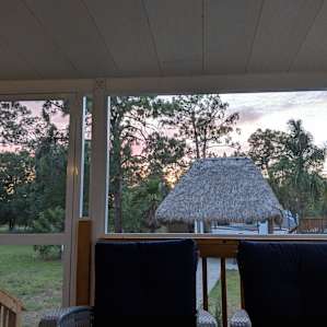 The sunset from the other enclosed porch overlooking the pool.
