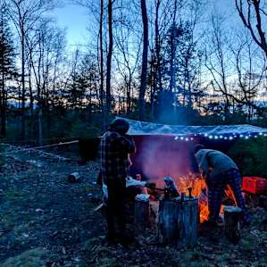 Campfire setup. Had a rainy weekend, so we hooked up a tent to nearby trees to stay dry - April 2019