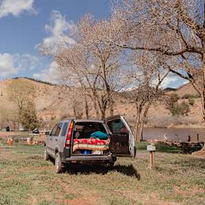 A nice flat parking spot and power hookup at this RV spot along the river!