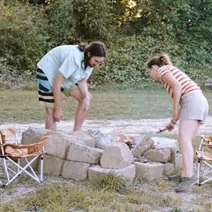 Starting a fire in the concrete block pit