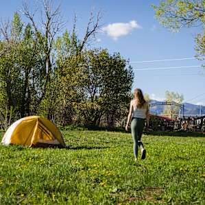 Set up your tent right in his field behind the house!