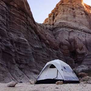 Set up camp close to the face of the red rocks.