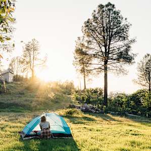 Setting up camp on the grassy knoll, fire pit to the right