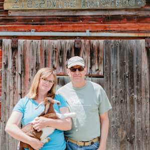 Landowners Randy and Allison, along with one of their young goats.