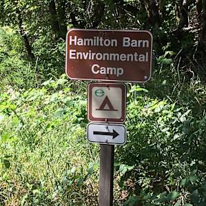 Small sign on north side of highway indicating the turn-off to the campground.