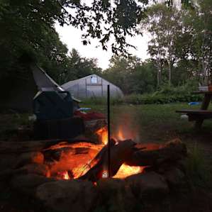 Camp site with greenhouse in background