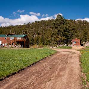 Driving up to the cabin (on the right). The airplane hanger and owner's home is on the left.