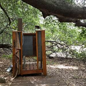 The outdoor shower under a giant oak tree