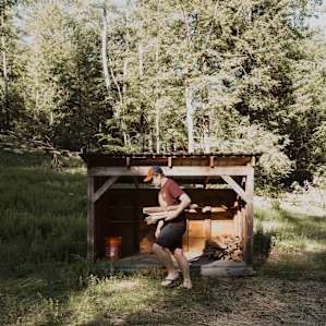 Lean-to for firewood, stocked with a hatchet and kindling too!
