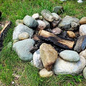 Firepit with provided kindling and firewood.