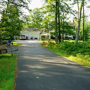 A view of the front of the property, there is a vehicle site off of the road to the right side, and enough room for multiple tents on the 30 acres around the back of the property.