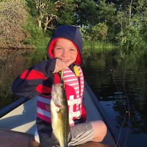 Happy boy with a largemouth bass