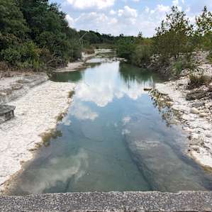 2 min away by car with good parking is this swimming hole just downstream of bridge. Yea!
