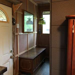 Entrance by the bunk beds and its trunk.