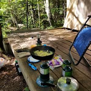 The single burner camp stove that came from the tent listing. We used the deck of the tent listing to make our food. We brought the cast iron pan and lighter from home.