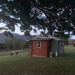 View of the tiny house from the bench/fire pit