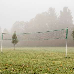 Volleyball net placed in the lawn of the Backwoods manor.