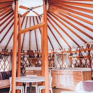 Inside of the yurt from the front door. Very bright since there are a lot of windows!