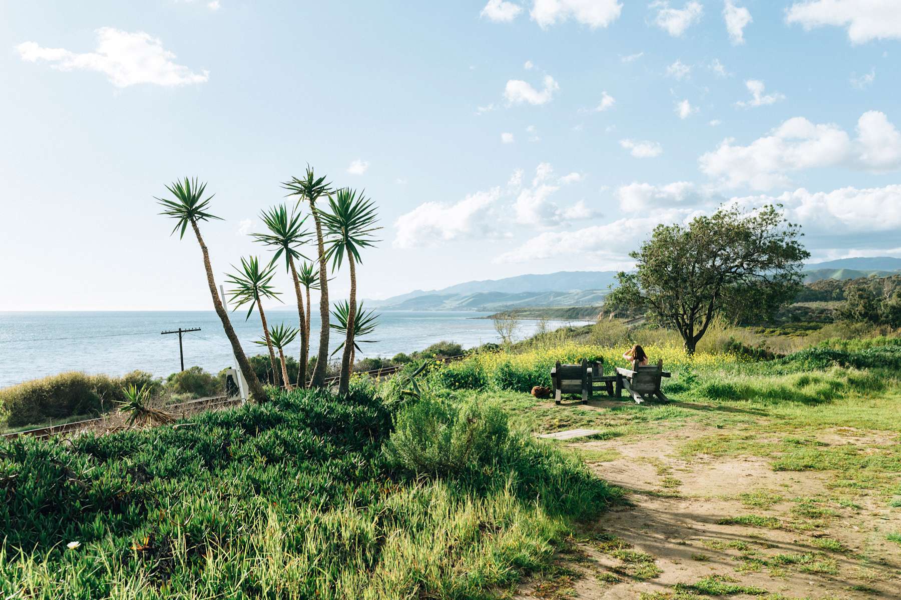 A landscape view of a Hipcamp location near Malibu. Shows a grassy hillside overlooking the ocean.