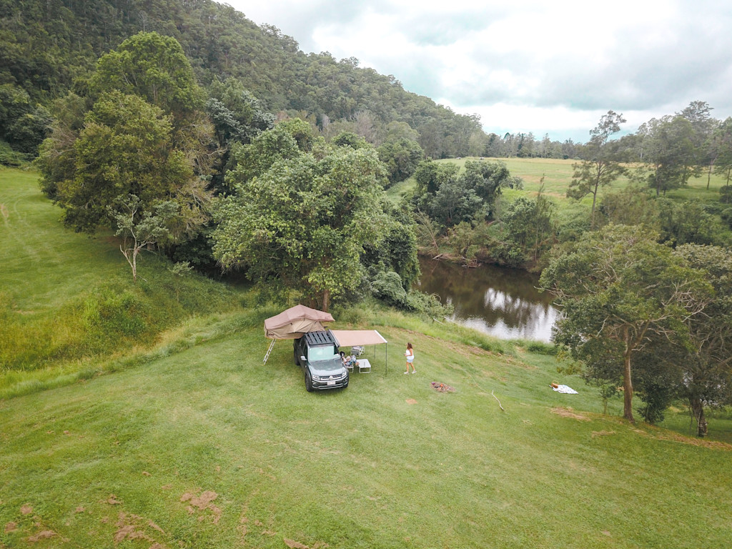 A wide-angle view of the riverfront campsite