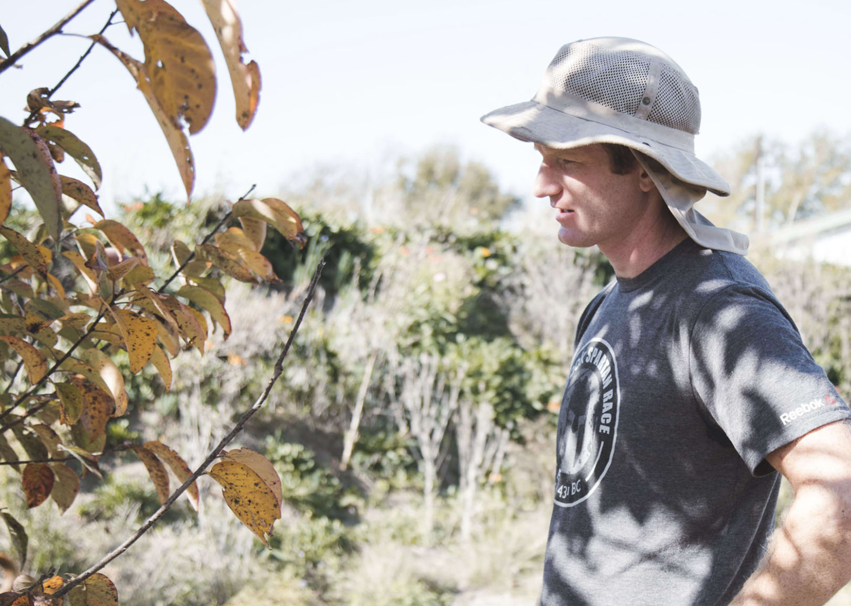 Rancher Emory Richey examines his orchard on his profitable Texas campground